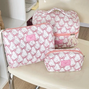 Detailed view of 3-piece quilted cosmetic bags with pink bow print and Good Night labels