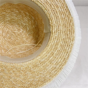 Detail of straw hat interior showing beige sweatband and adjustable drawstring