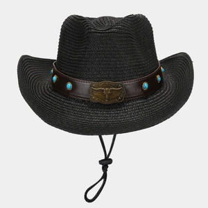 Detail of western straw hat featuring a bronze bull head buckle and turquoise beads