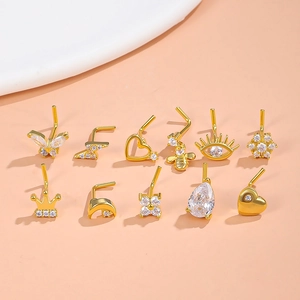 Set aus goldenen Bauchnabelpiercings mit Zirkonia-Anhängern wie Schmetterling und Krone