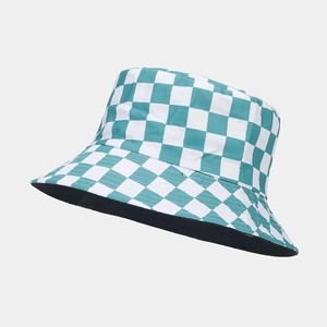 Detail view of double-sided bucket hat with mint green checkered pattern and reinforced stitching