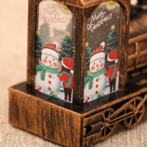 Close-up of vintage bronze Christmas train lantern with snowman and Merry Christmas text