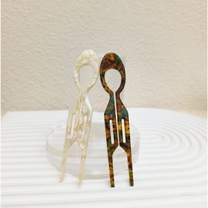 U-shaped acetate hair pins in marble white and tortoiseshell patterns for elegant styling