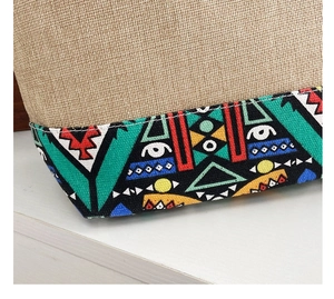 Close-up of ethnic canvas bag showing linen texture and colorful geometric tribal patterns