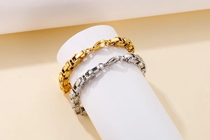 Detailed macro of gold and silver chunky curb link chains with lobster clasp closure