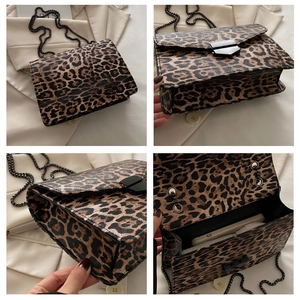 Detail of leopard print shoulder bag showing metal chain strap and interior phone pocket