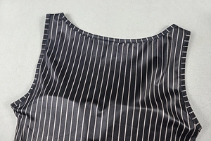 Detailed close-up of neckline and shoulder on black and white striped strapless crop top