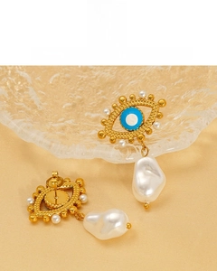 Detailed close-up of Evil Eye earrings with 18K gold plating and Baroque pearls
