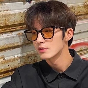 Chic oversized black frame sunglasses with orange gradient lenses worn by model