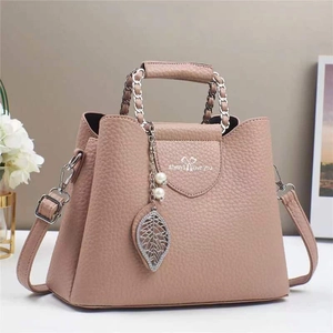 Elegant dusty rose faux leather shoulder bag with lychee texture and leaf pendant charm