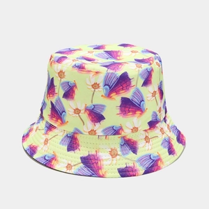 Detail of light green bucket hat featuring colorful butterfly and daisy floral prints