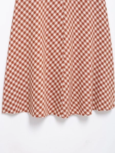 Detailed close-up of the red and white gingham fabric hem with clean stitching