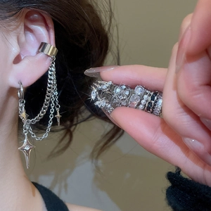 Close-up of silver tassel ear cuff with star charms and sparkling zircon rings