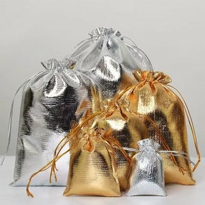 Detailed view of metallic gold and silver drawstring gift bags in various sizes