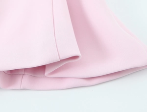 Close-up of pink halter top showing high-quality fabric texture and neat stitching