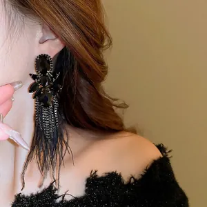 Dark gothic drop earrings with black gemstone crystals, metallic tassels and soft feathers