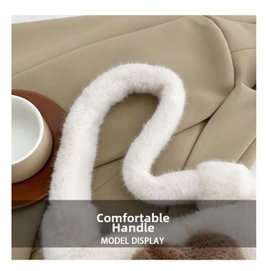 Close-up of the thick fluffy handle and soft white faux fur texture of the shoulder bag