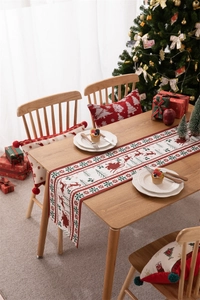 Detailed Christmas table runner and placemats with reindeer patterns in festive setting