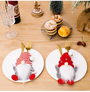 Christmas gnome cutlery holder detail on wooden table with festive holiday decorations