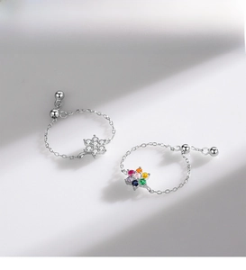 Macro shot of S925 sterling silver adjustable rings with colorful snowflake pendants