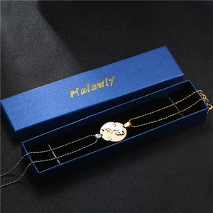 Detailed view of gold and silver cat couple necklace inside a blue gift jewelry box