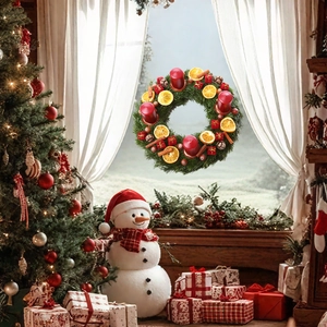 Christmas wreath detail with red candles, orange slices, and berries for home decor