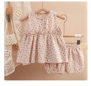 Detail of baby floral cotton sleeveless top and bloomers with soft ruffled textures