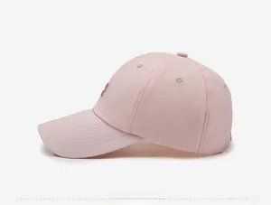 Side view of a breathable pink baseball cap featuring purple embroidery detail