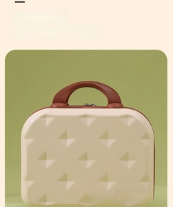Detail of the 14-inch mini suitcase with geometric texture and sturdy handle