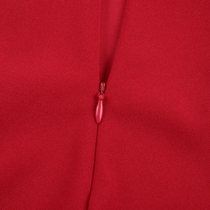 Close-up of the high-quality invisible zipper and red fabric texture on the sexy dress