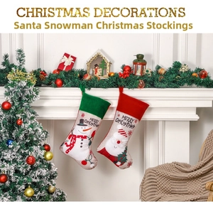 Close-up of Santa and Snowman stockings hanging on a white fireplace with Christmas decor