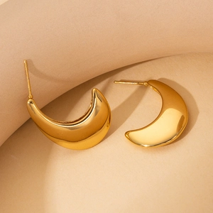 Macro detail of crescent moon earrings with high polished gold stainless steel finish