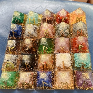 Detailed top view of 25 crystal resin energy pyramids with golden runes and gold foil