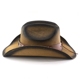 Macro shot of vintage straw cowboy hat featuring intricate embroidery and leather band detail