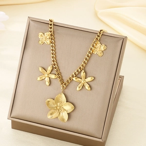 Close-up of a golden flower pendant necklace in a premium gift box on silk