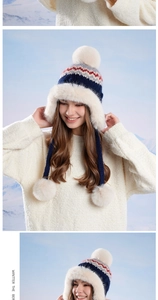 Detail of the navy Fair Isle knit trapper hat with thick white faux fur lining and earflaps