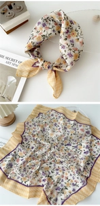 Macro detail of cotton linen floral scarf with yellow grid borders and rolling hem edges
