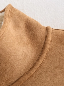 Close-up of camel suede jacket with white faux shearling lining and premium stitching
