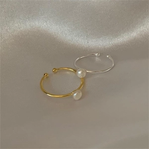 Minimalist S925 sterling silver pearl ear clips in gold and silver finish on silk fabric