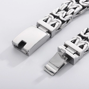 Macro detail of silver stainless steel Byzantine chain with secure lobster clasp closure
