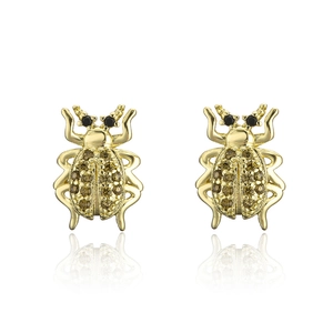 Detailed view of gold-plated beetle earrings with amber and black cubic zirconia stones
