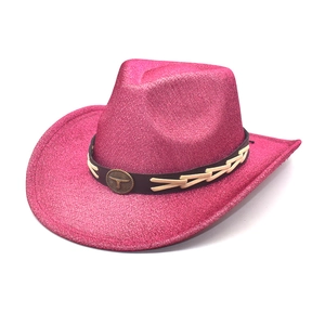 Close-up of hot pink sequin cowboy hat with bronze bull head emblem and leather band