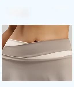 Detail of high-waisted yoga pants with V-shaped crossover waistband in beige and brown