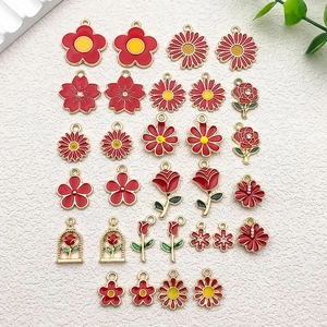 Flat lay of red and yellow enamel flower charms for DIY jewelry making accessories