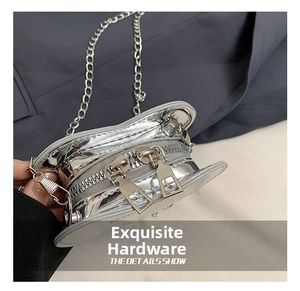 Detail of silver metallic mini bag featuring dual zippers and fine chain strap