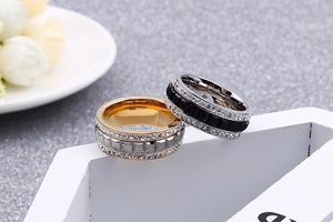 Macro view of rose gold and black stainless steel rings with crystal pave settings