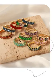Macro view of colorful baguette cut zircon stone rings set on travertine stone