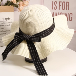 Chic wide-brim straw sun hat with black ribbon bow for summer beach vacation