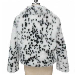 Close-up of fluffy faux fur texture with black and white Dalmatian leopard spots