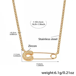 Detailed view of gold paperclip necklace with zircon pavé heart charm and dimensions